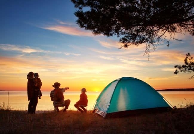 Family tent camping at lake
