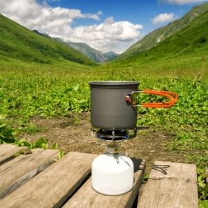 Cooking in backpacking stove with mug camping
